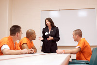 woman speaking to inmates