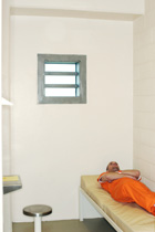 inmate lying in bed