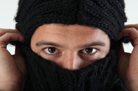 person putting on a balaclava