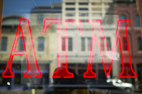 the letters ATM in neon