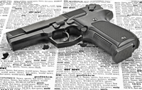 a pistol sitting on a newspaper