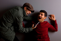 a person holding a pistol to another person's chin