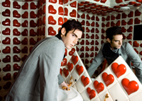 a person staring into a mirror with hearts on walls