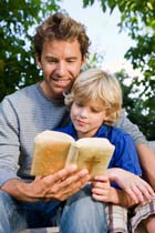 a person reading a bible with a child