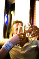 two people clink champagne glasses