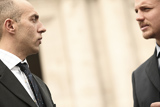 two people in suits talking