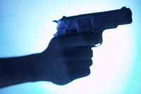 a hand holds a pistol
